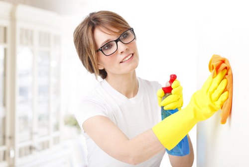 Local curtain cleaner working in a Clapham flat with careful access